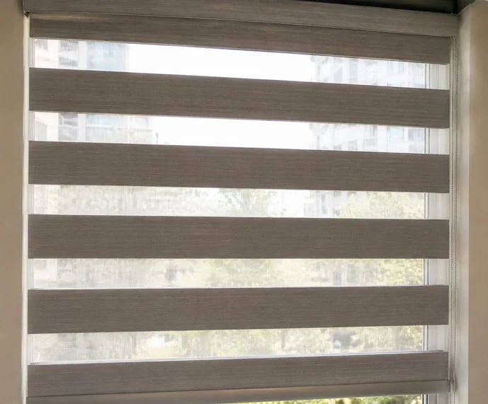 Shadesmart zebra blind fabric showing alternating opaque and sheer stripes with light coming through